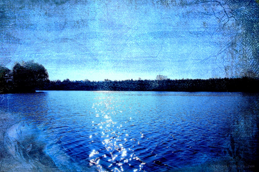Blue lake with sun reflection