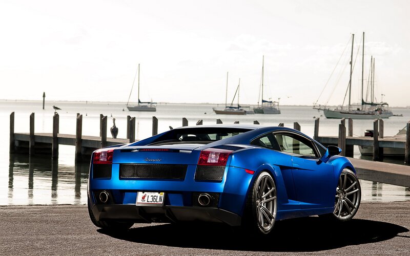 Blue Lamborghini at a marina