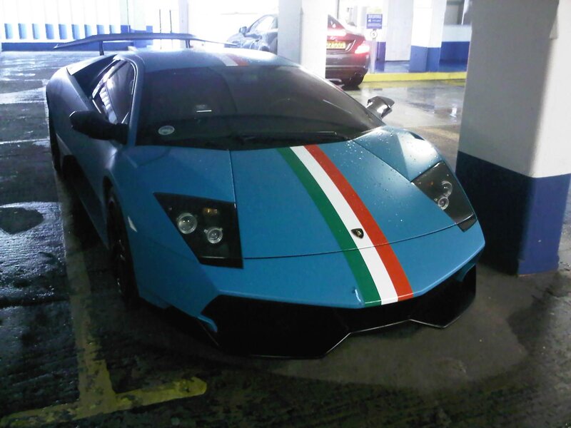 blue lamborghini in parking garage