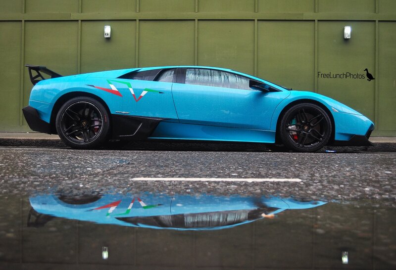 Blue Lamborghini in puddle reflection