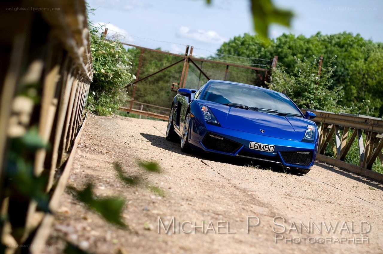 Blue Lamborghini on a dirt road