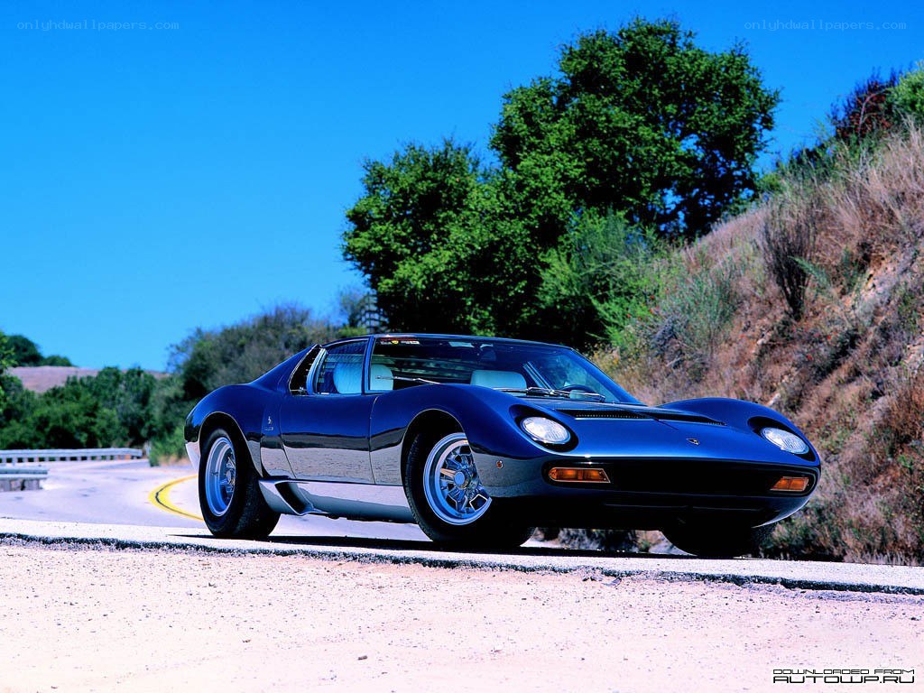 Blue Lamborghini on a winding road