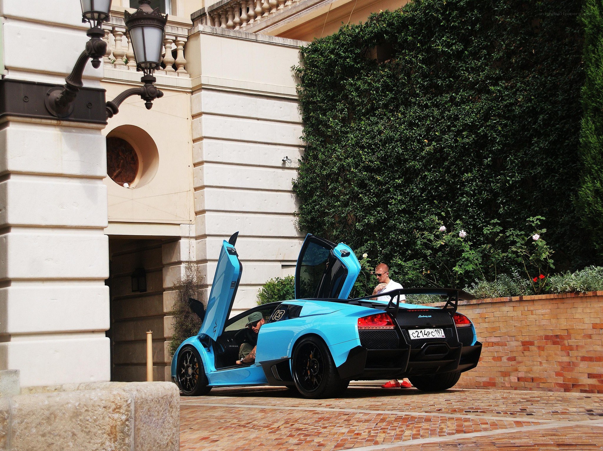 Blue Lamborghini with doors open