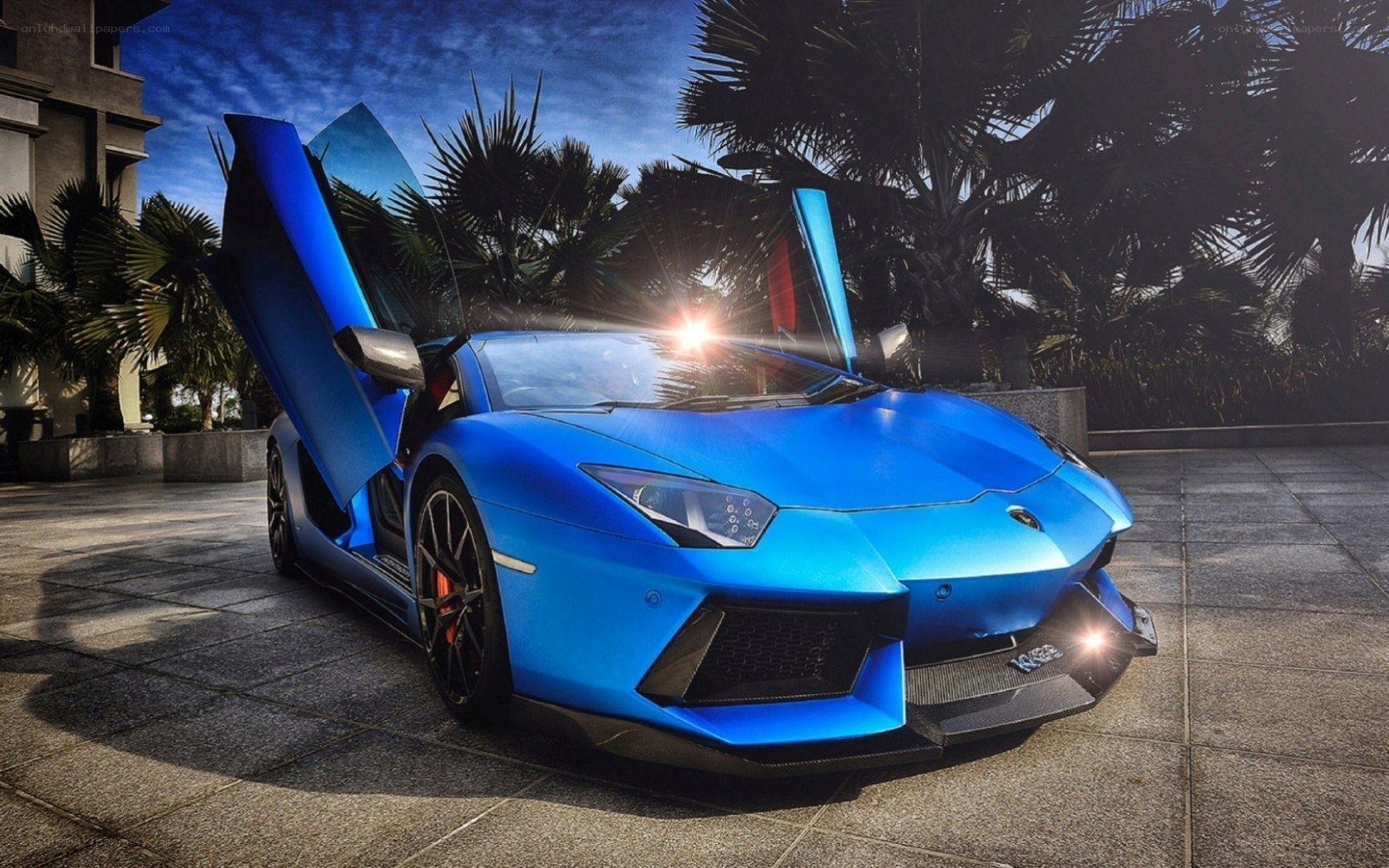 blue lamborghini with doors open