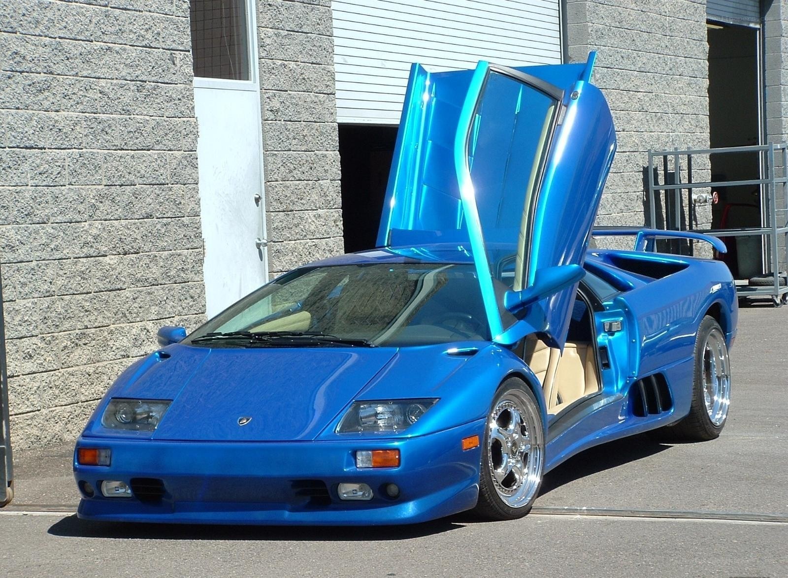 Blue Lamborghini with doors open