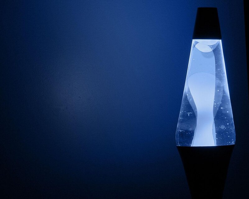 blue lava lamp in dark room