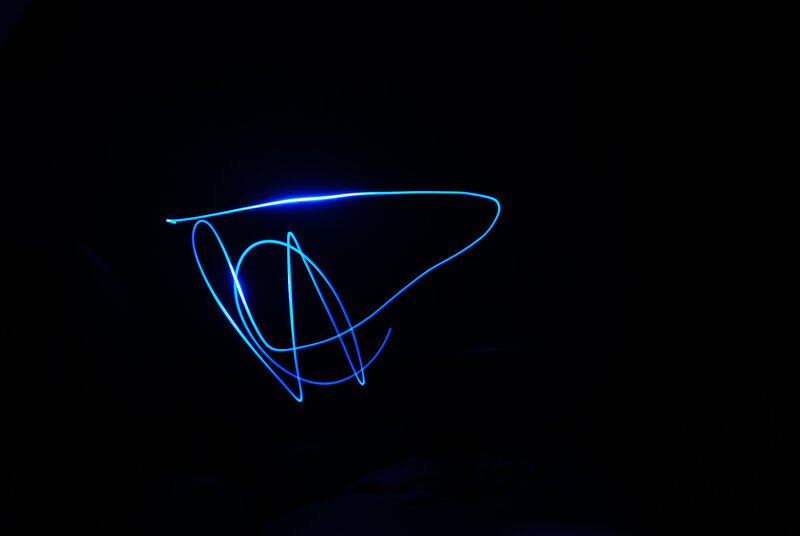 blue light drawing in darkness