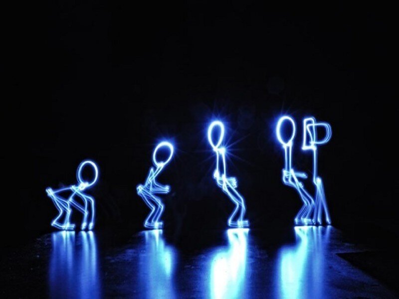 blue light stick figures dancing