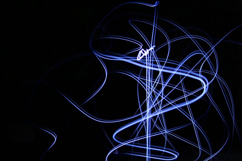 Blue light trails on black background
