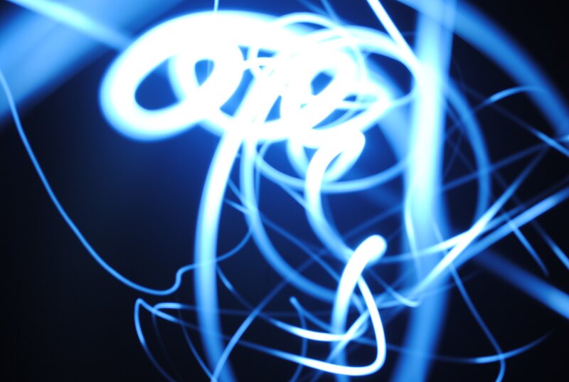 blue light trails on dark background