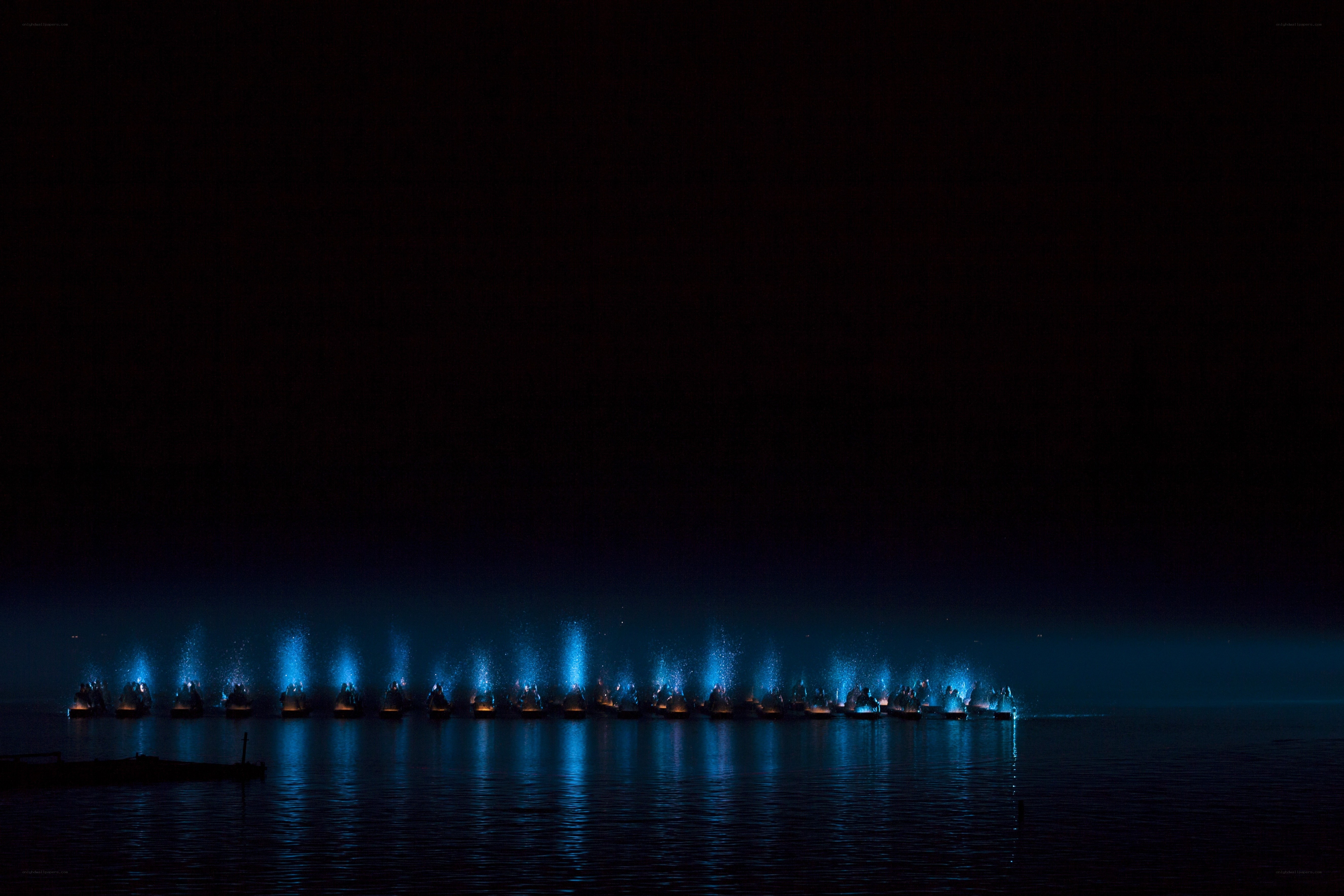 Blue lights on water at night
