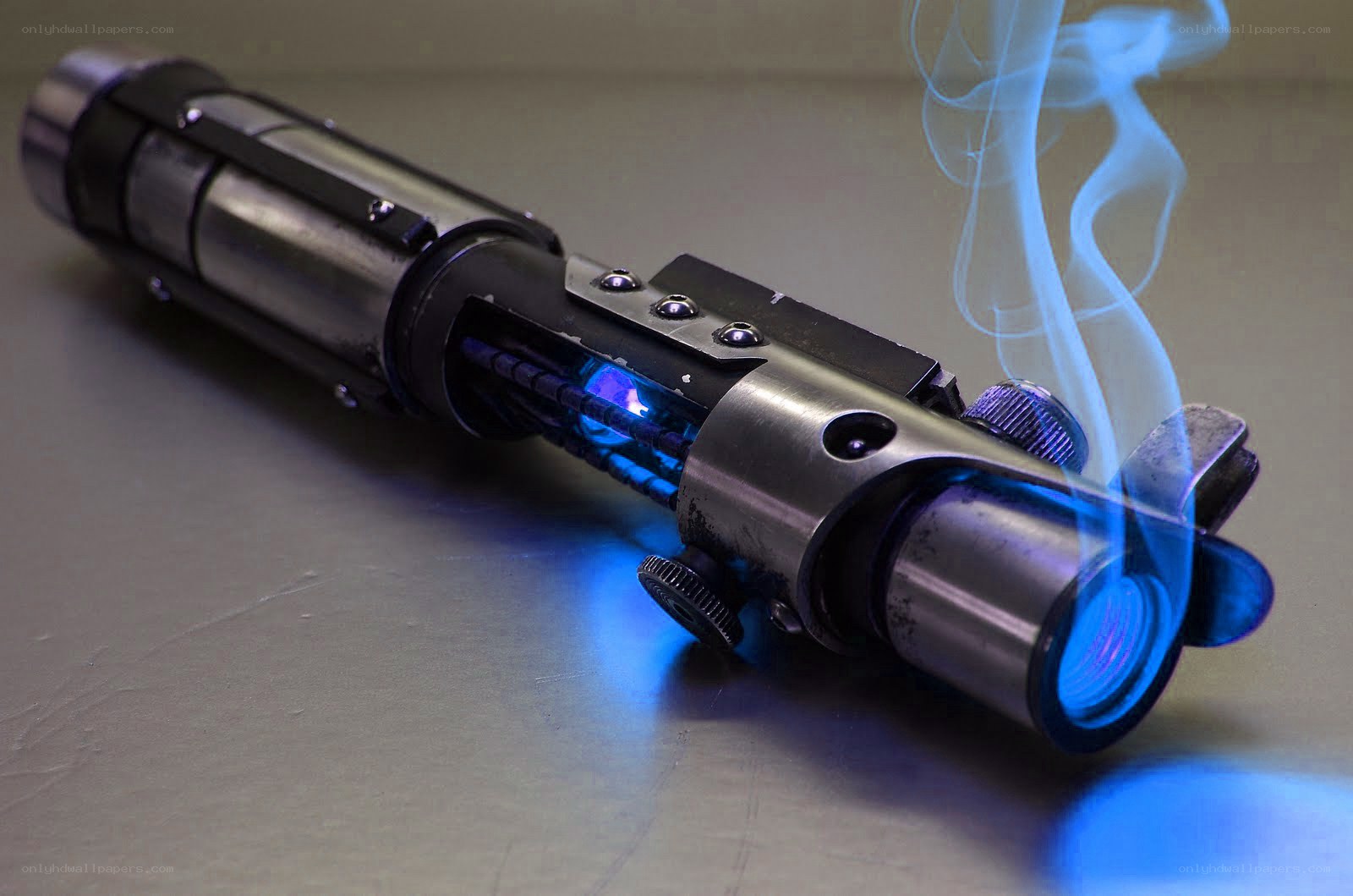 blue lightsaber with smoke