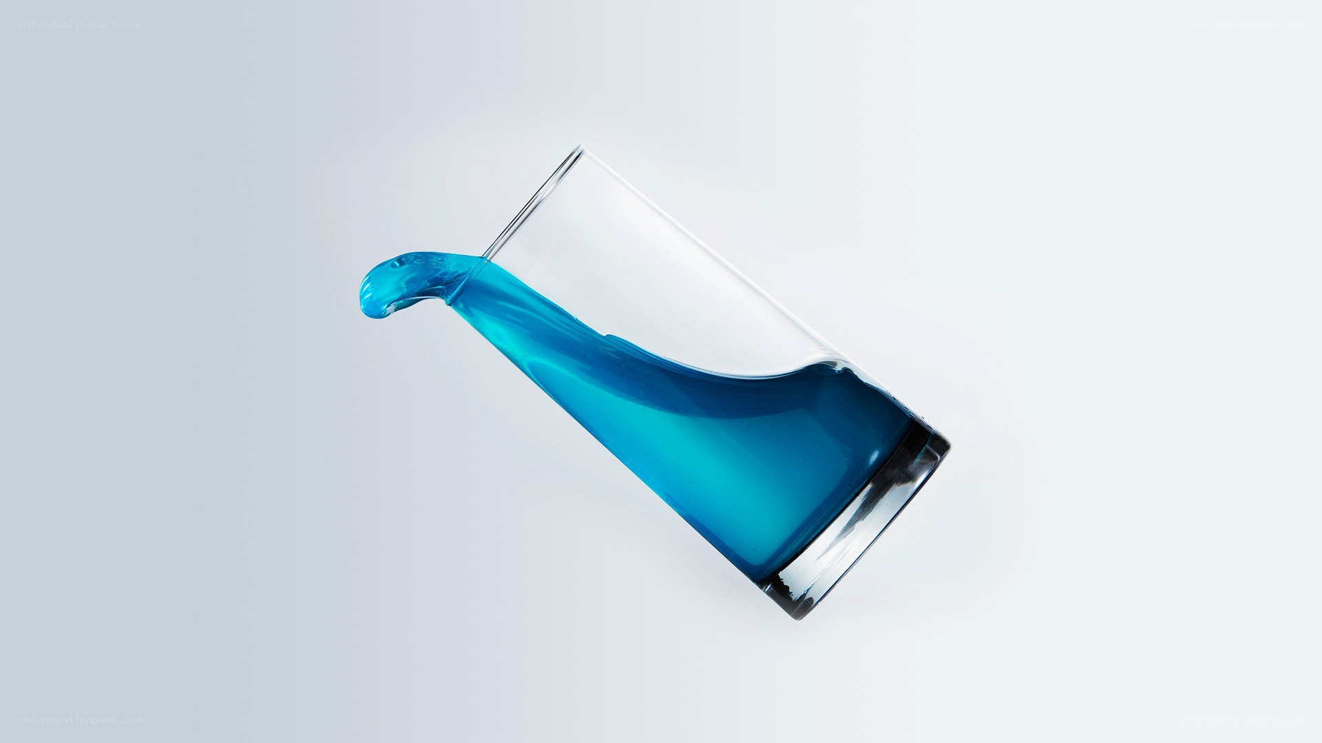 blue liquid pouring from glass