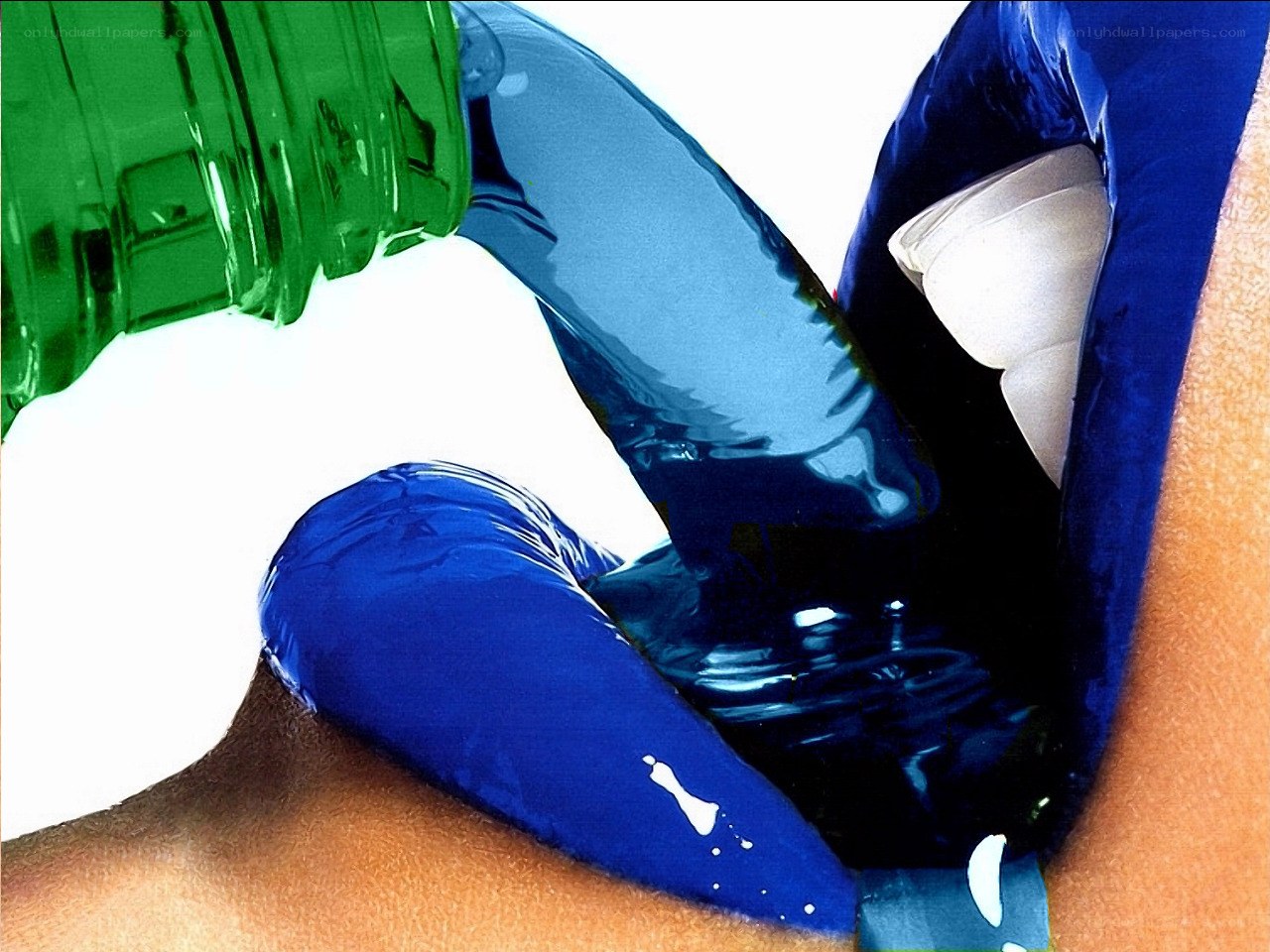 Blue liquid pouring from green bottle