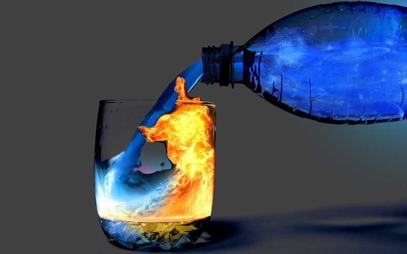 blue liquid pouring into glass