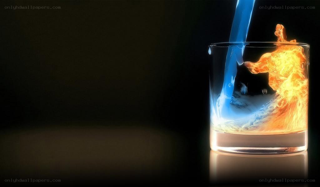 Blue liquid pouring into glass with fire