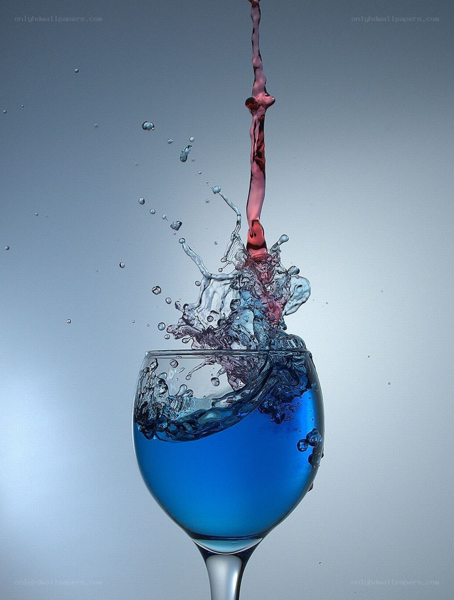blue liquid splashing in glass