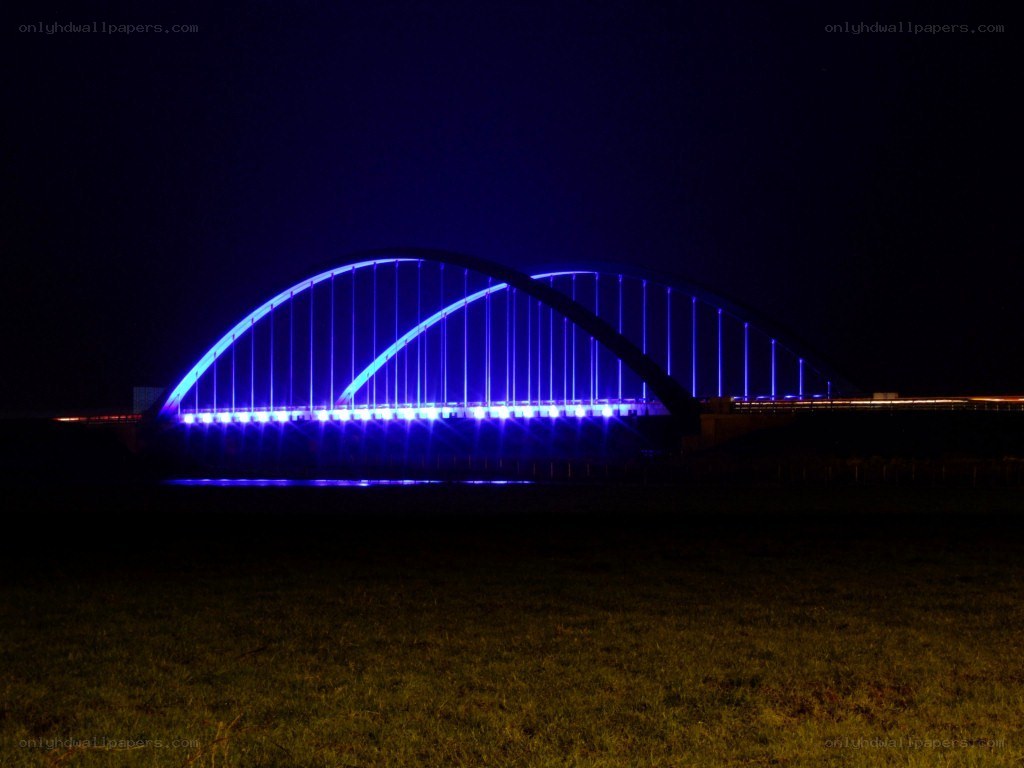 Blue-lit bridge at night