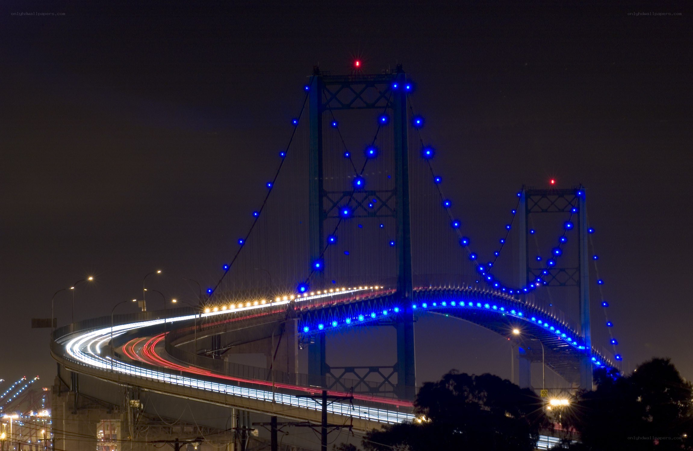 Blue-lit bridge at night
