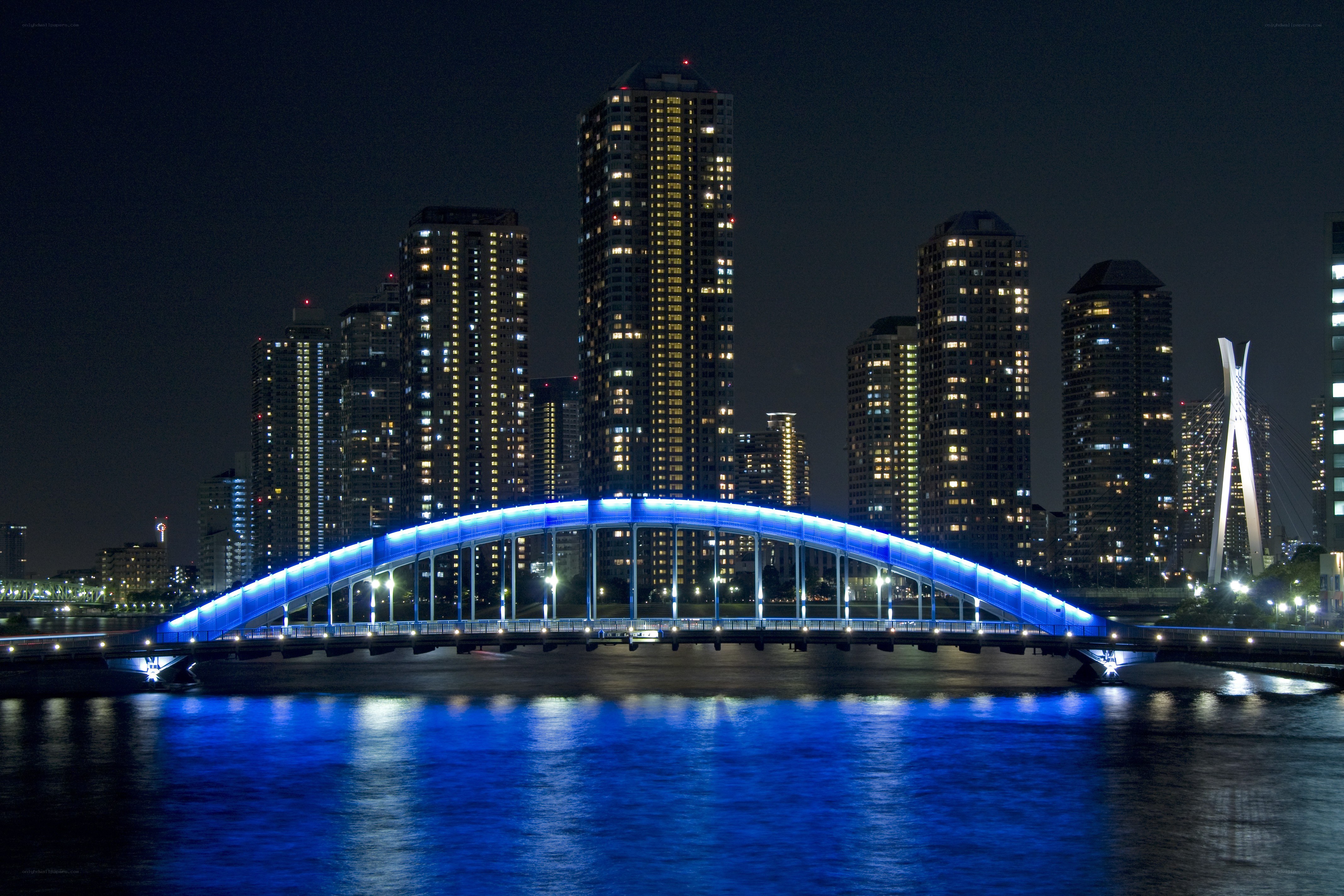 Blue-lit bridge at night