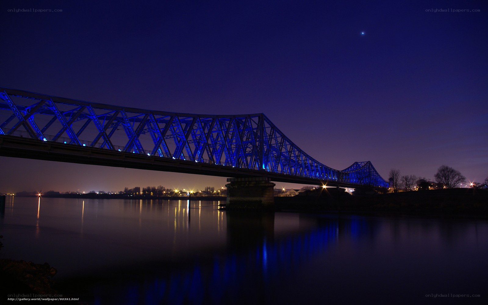 Blue-lit bridge at night