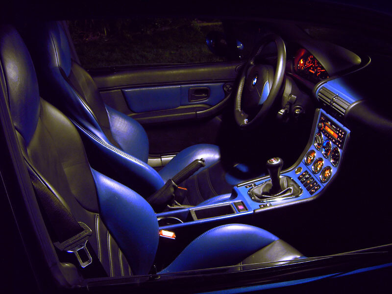 blue-lit car interior at night
