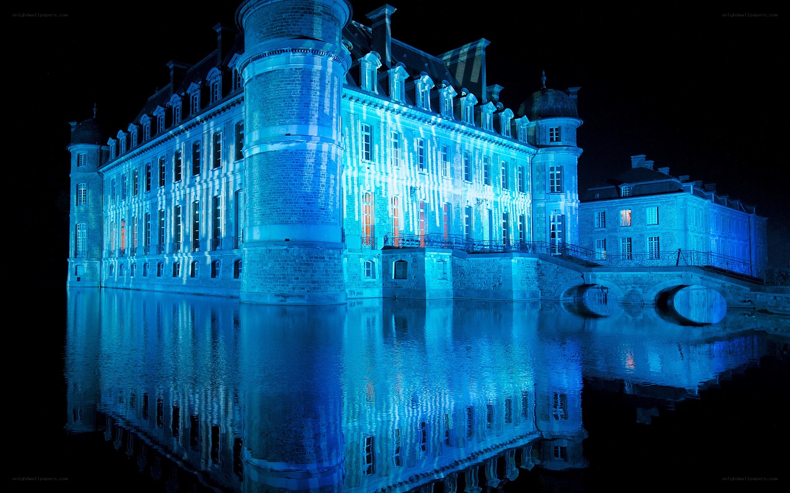 blue-lit castle at night