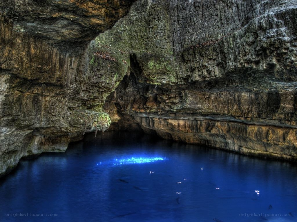 Blue-lit cave pool