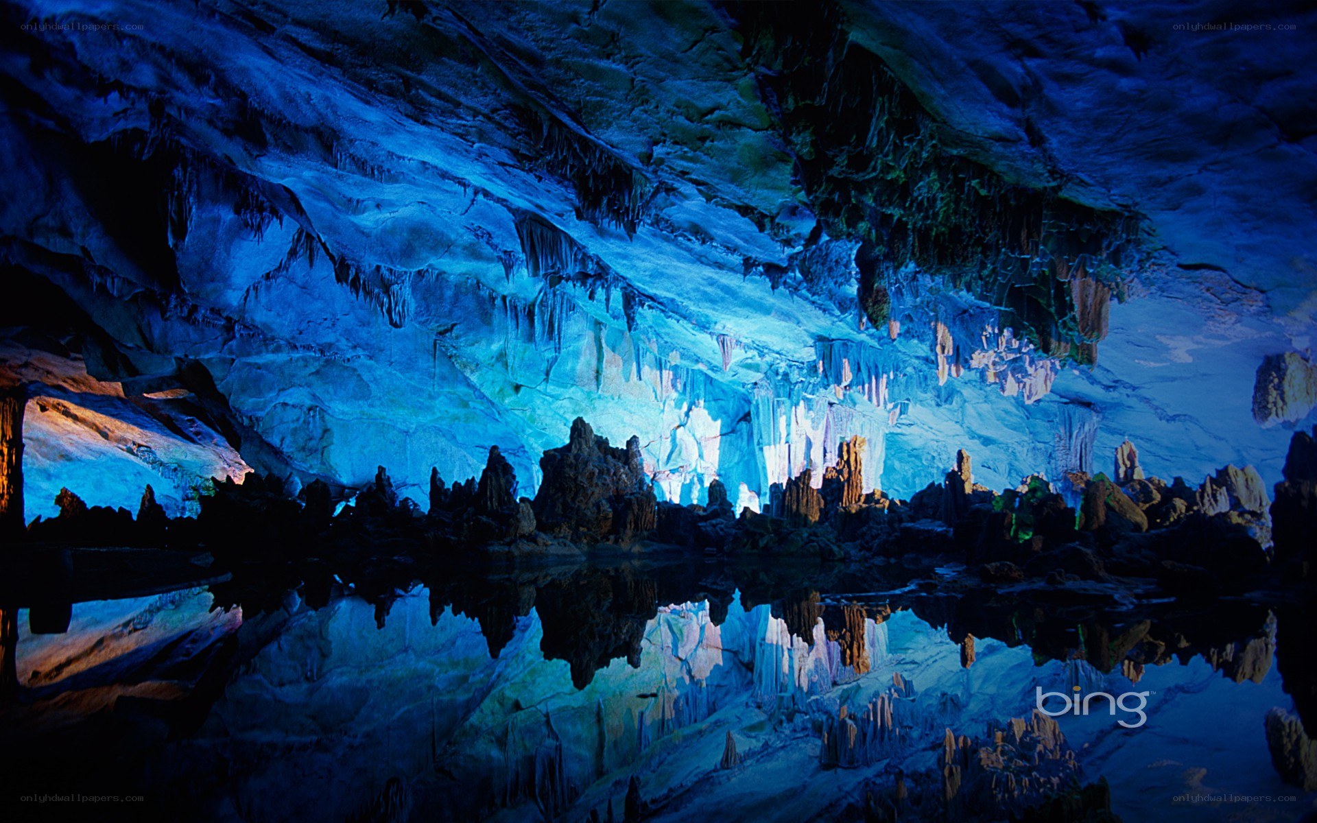 Blue-lit cave with stalactites