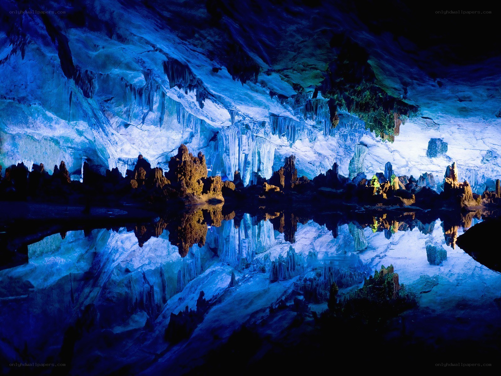 Blue-lit cave with stalactites