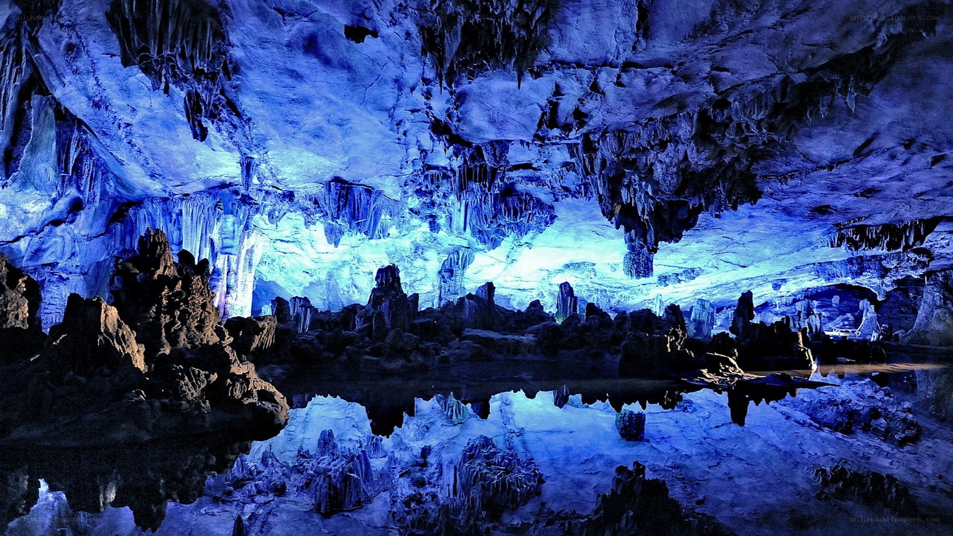 Blue-lit cave with stalactites