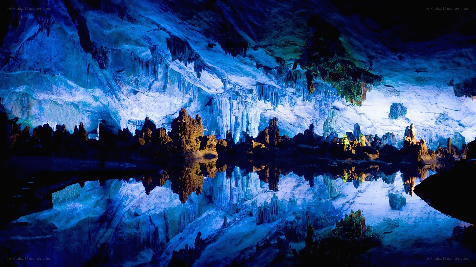 Blue-lit cave with stalactites