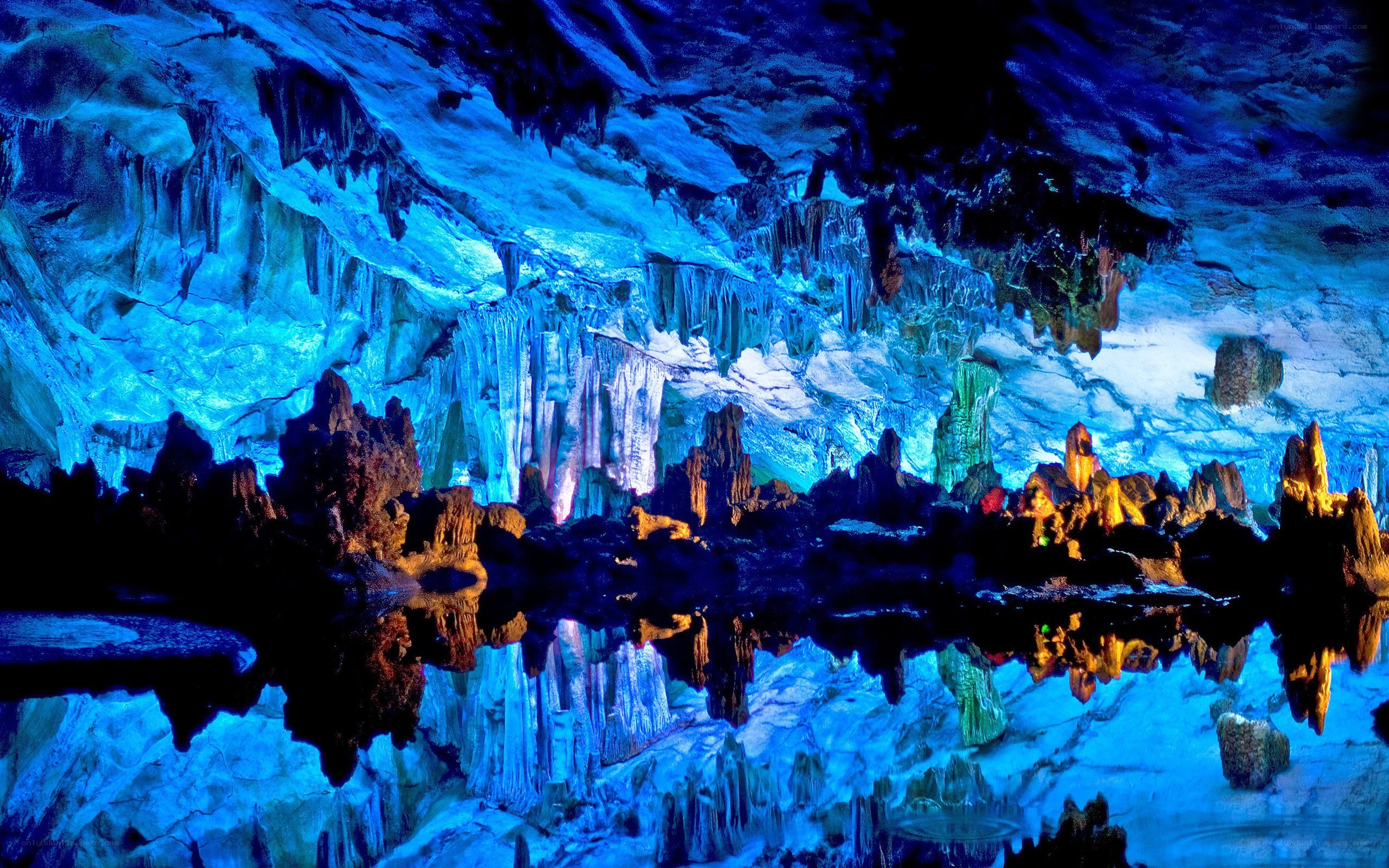 Blue-lit cave with stalactites