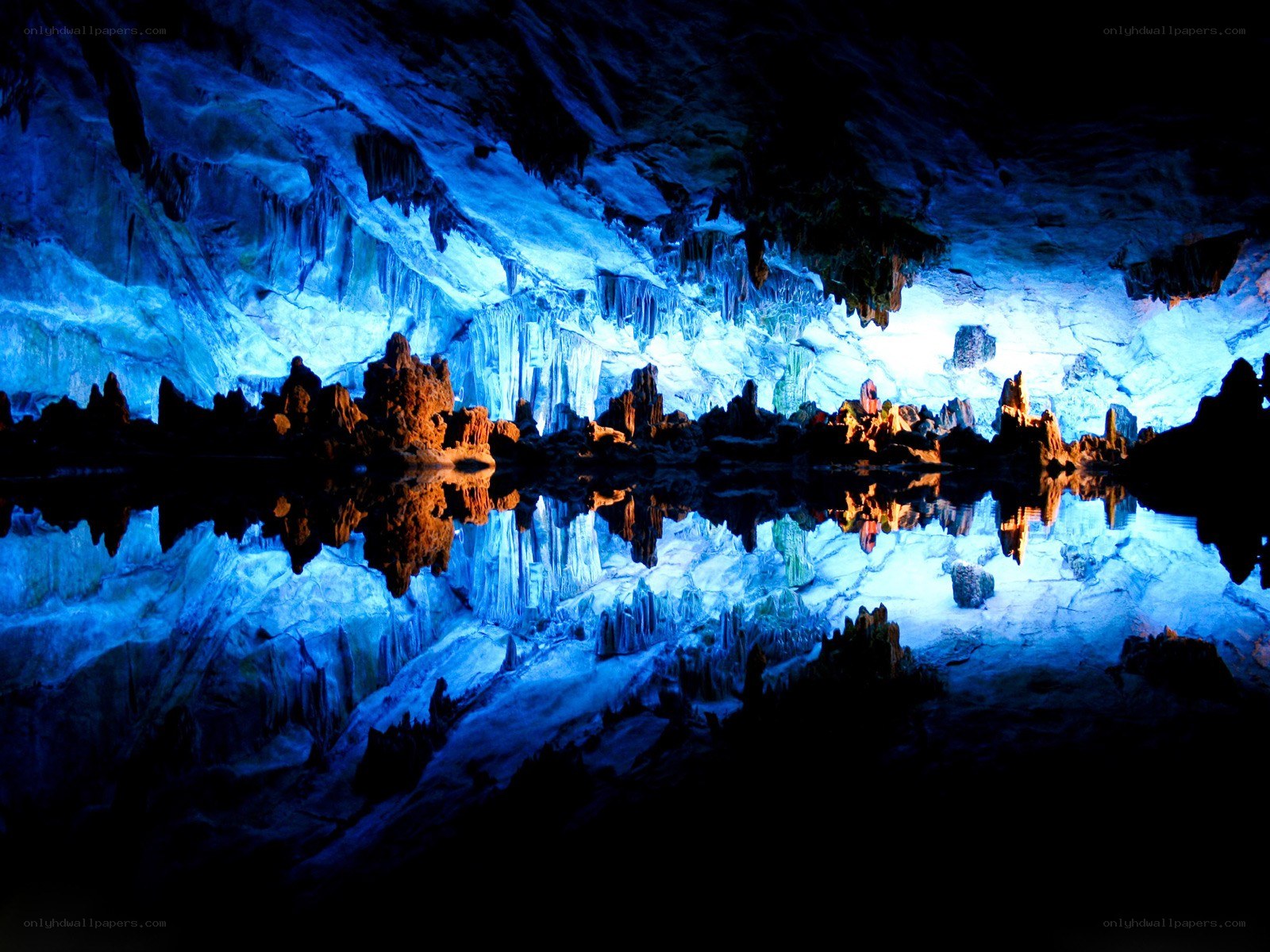 Blue-lit cave with stalactites