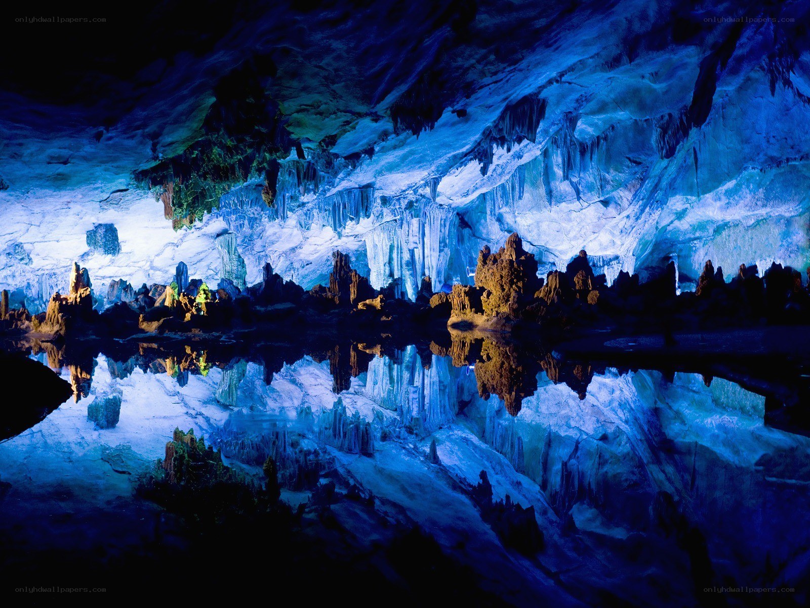Blue-lit cave with stalactites