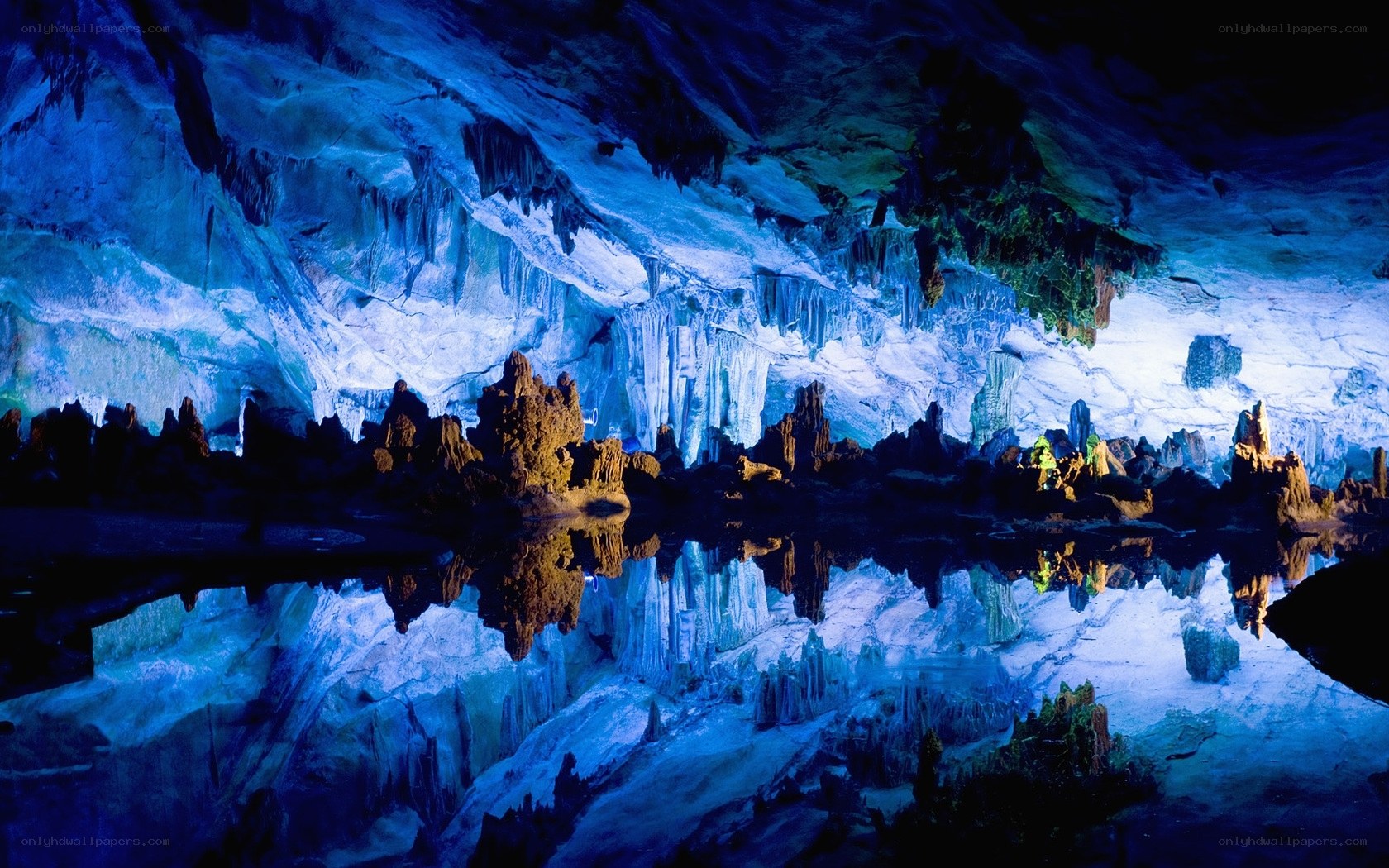 Blue-lit cave with stalactites
