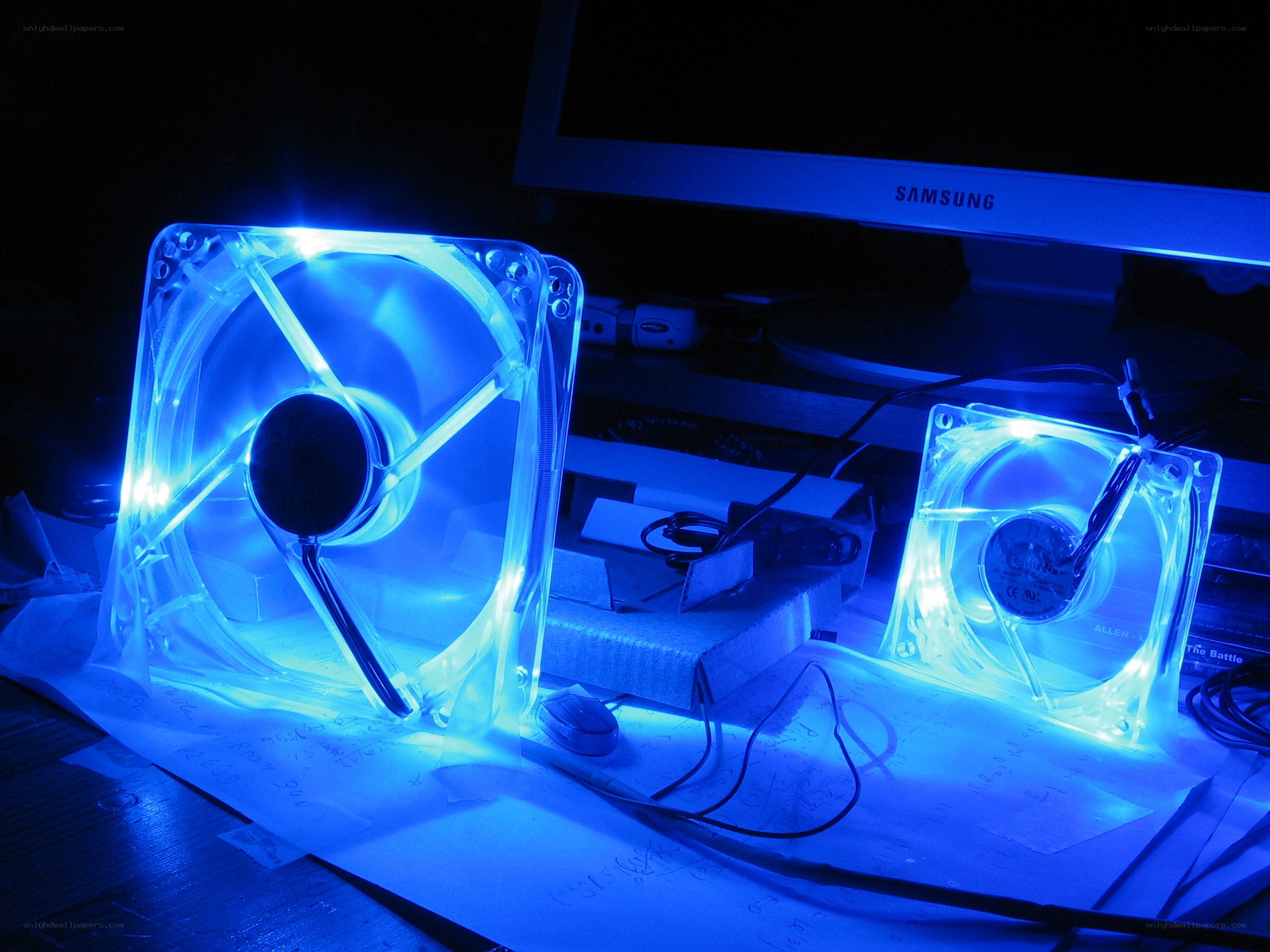 Blue-lit computer fans on desk