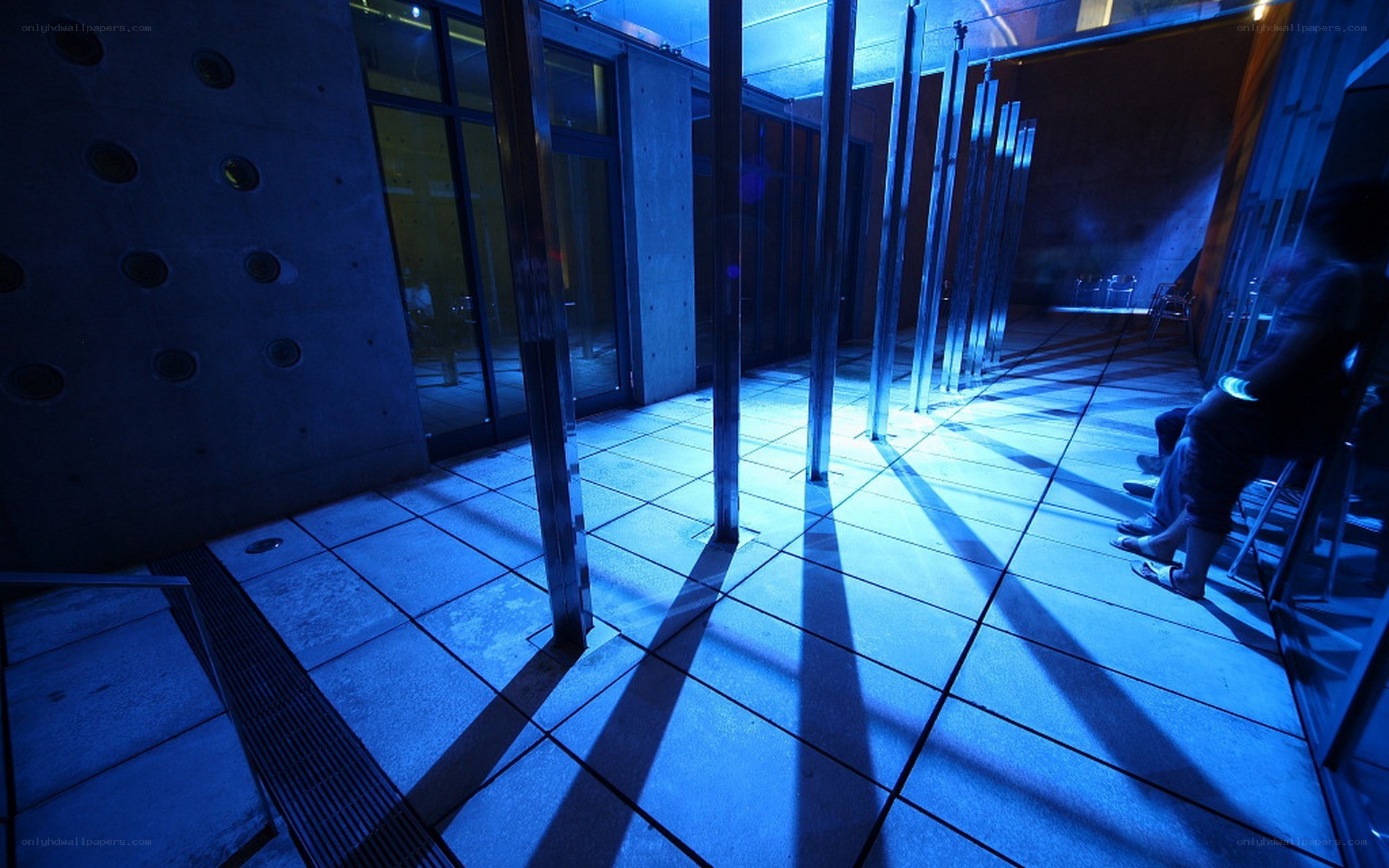 Blue-lit corridor with silhouetted figure
