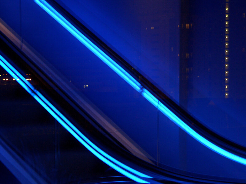 Blue-lit escalator at night