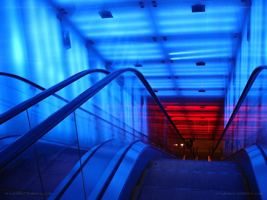 Blue-lit escalator tunnel