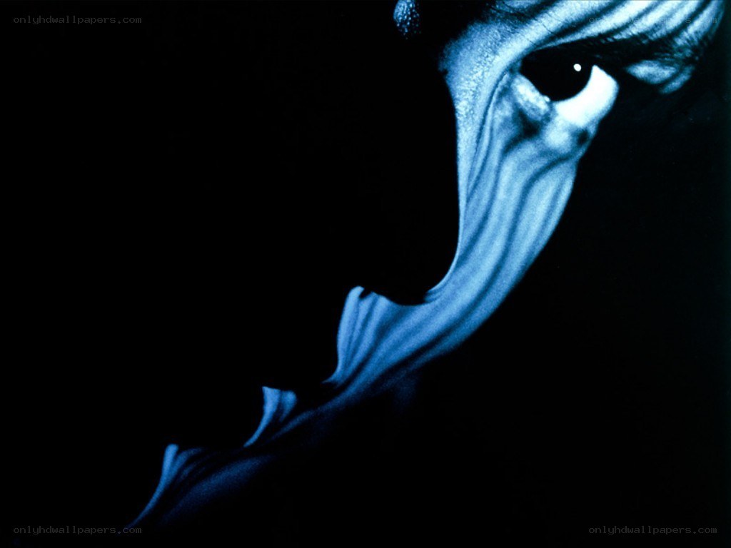 blue-lit face in darkness