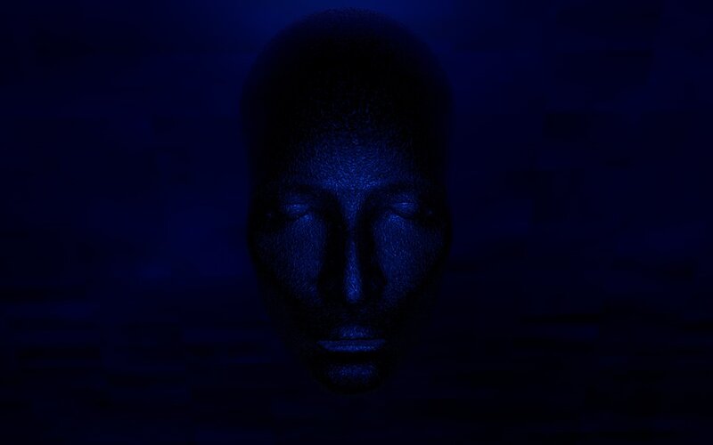 blue-lit face sculpture