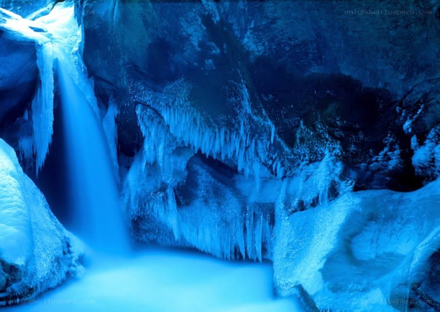 Blue-lit ice cave waterfall
