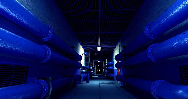 blue-lit industrial pipe corridor