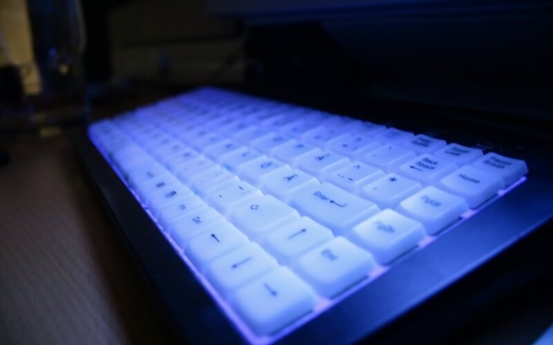 blue-lit keyboard in dark room