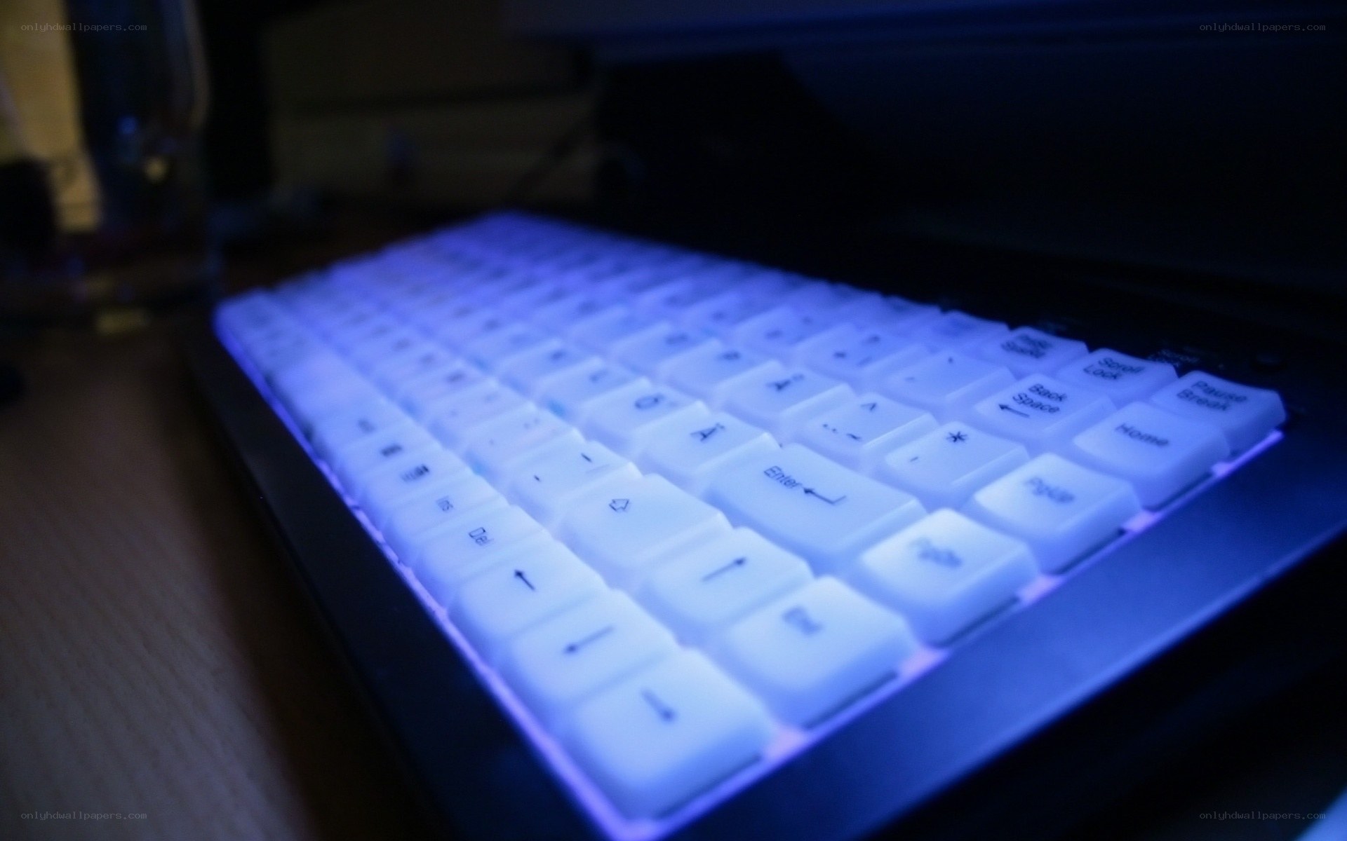 blue-lit keyboard in dark room