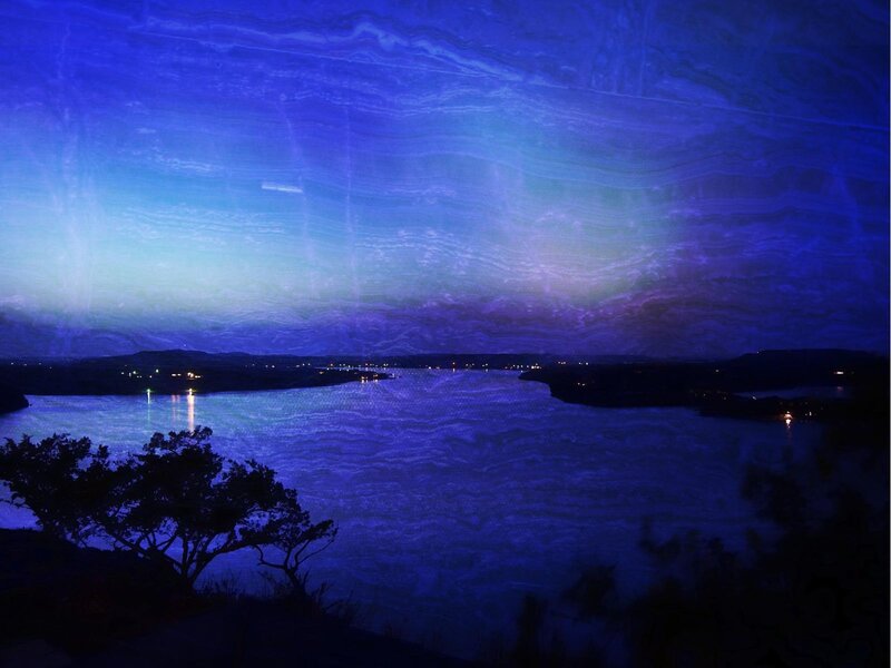 Blue-lit lake at night