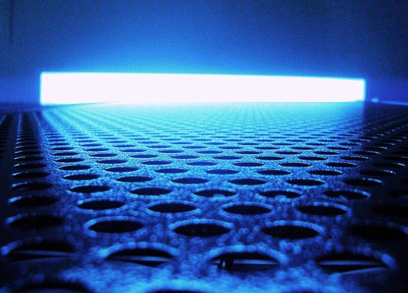 blue-lit perforated surface