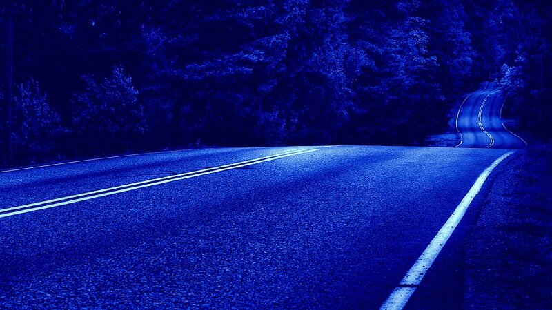 blue-lit road at night