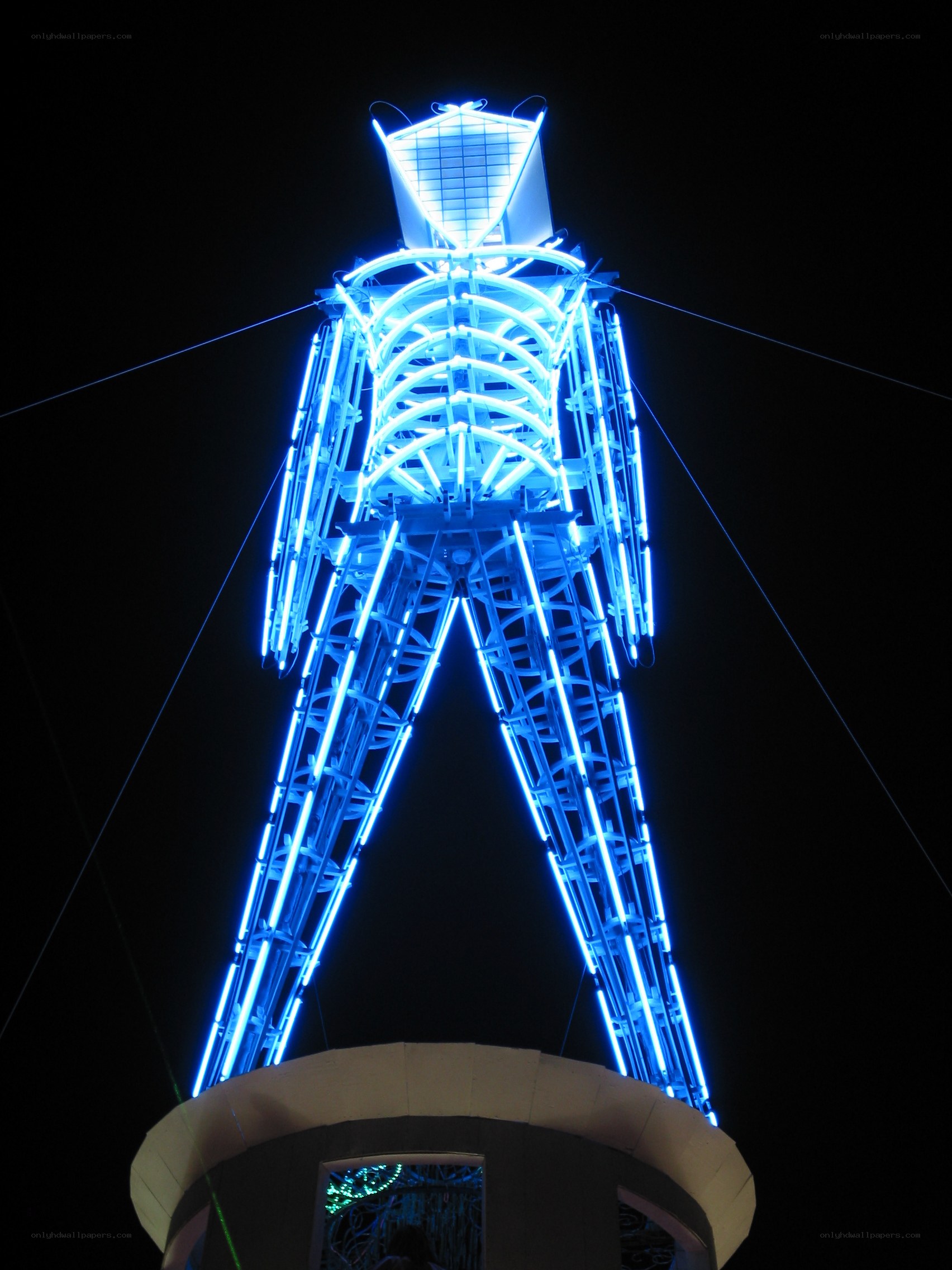 blue-lit sculpture at night